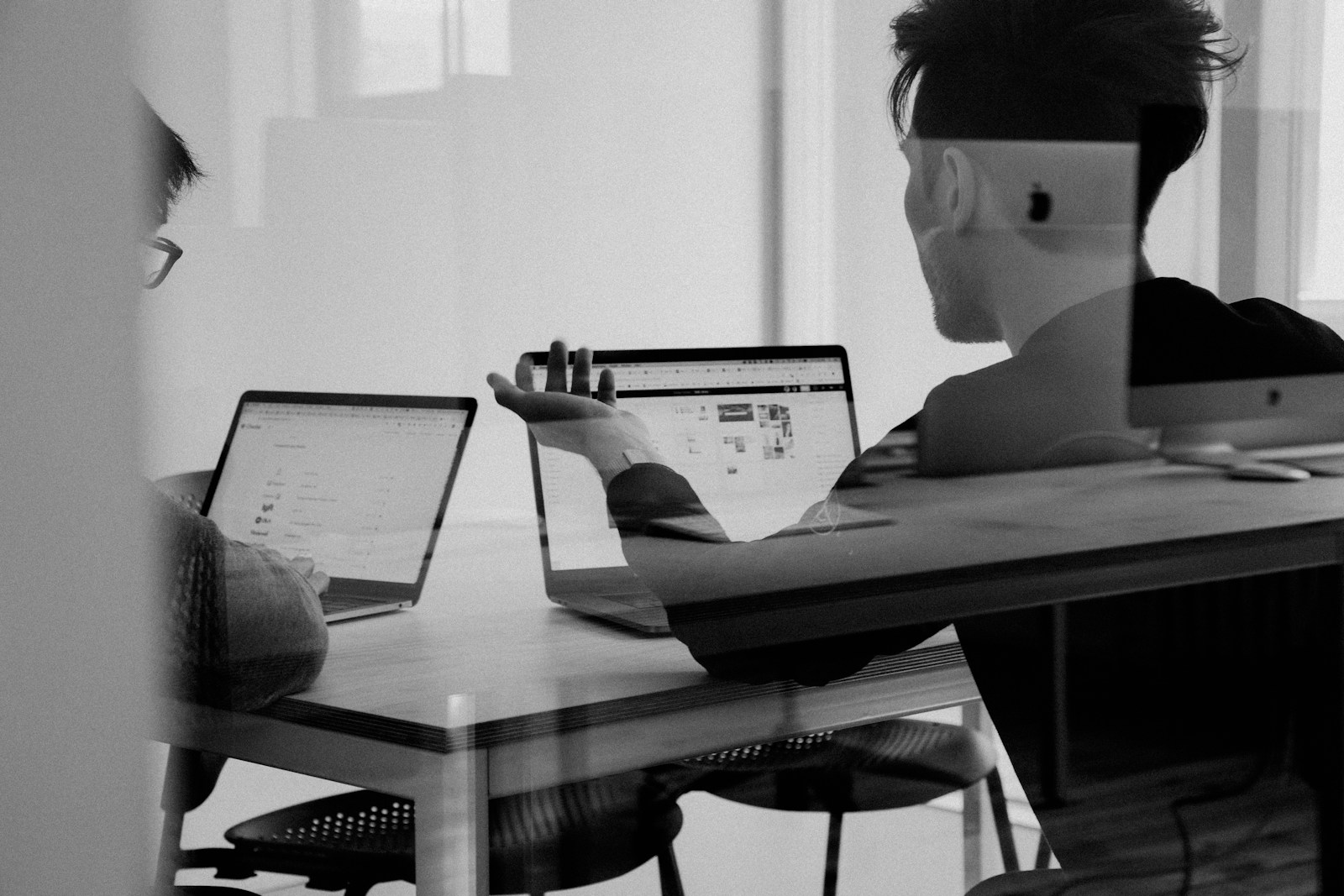 Strategist managing Google Ads and Meta Ads campaigns at a workstation